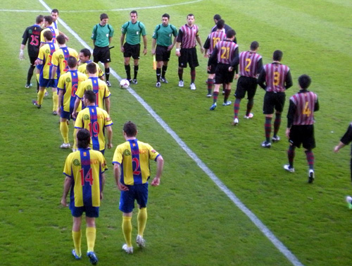 El Palamós i el Júpiter sortint a la gespa del Nou Estadi, aquesta tarda. (Foto: Sergi Cortés).