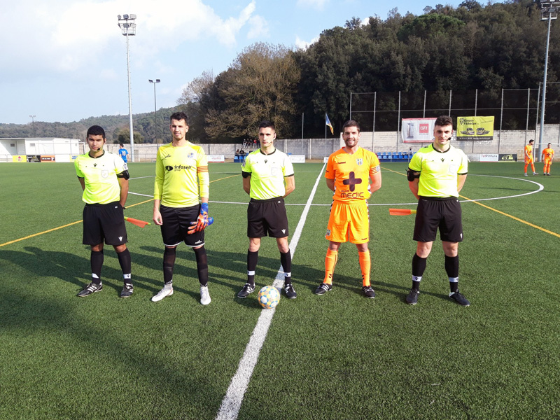 El capità David Cano, amb el seu homòleg del Bescanó i la tripleta arbitral, abans del partit de dissabte. (Foto: Palamós CF).