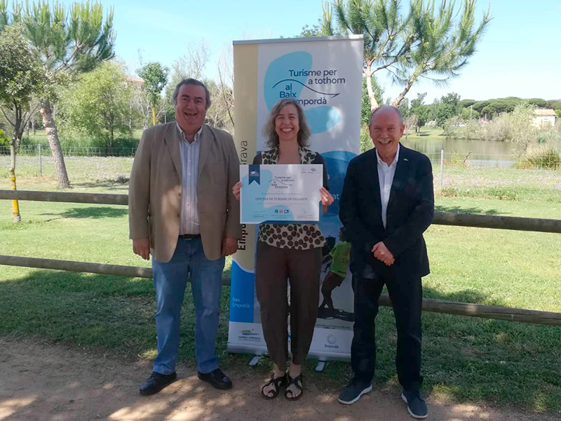 La regidora de Turisme i Cultura, Núria Botellé, recollint el distintiu de la mà del president del Consell Comarcal, Joan Loureiro, i del conseller de